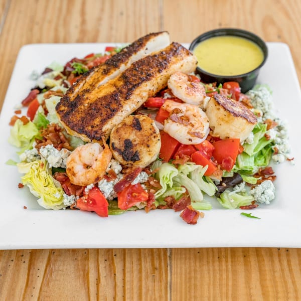 Jumby Bay Island Grill's seafood salad with blackened fish, grilled shrimp, scallops, and dressing.